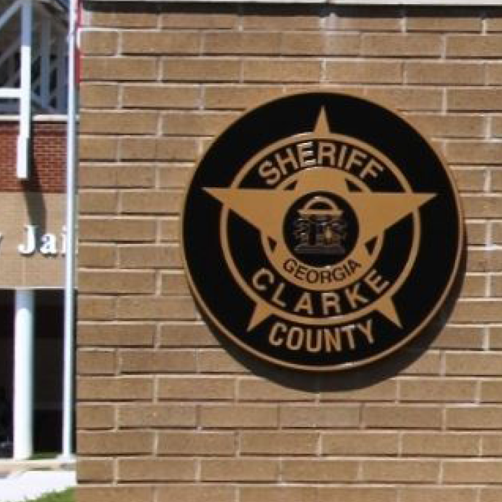 A brick wall with the sheriff of clarke county logo on it.